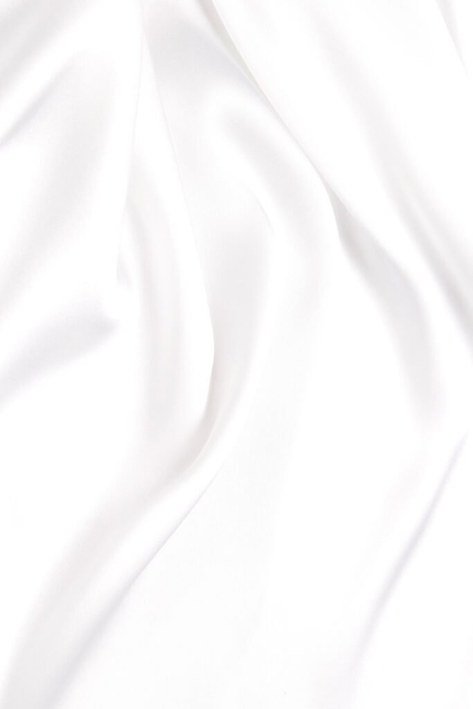 Abstract white fabric texture background. Cloth soft wave. Creases of satin, silk, and cotton.