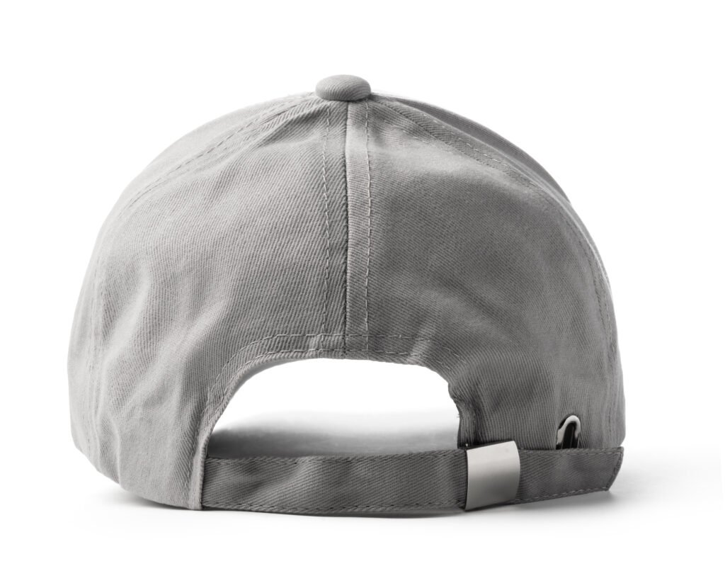 A gray baseball cap is placed on a plain white background. The cap is structured with a curved brim and a adjustable strap at the back. It is made from durable fabric and designed for sports activities or casual wear.